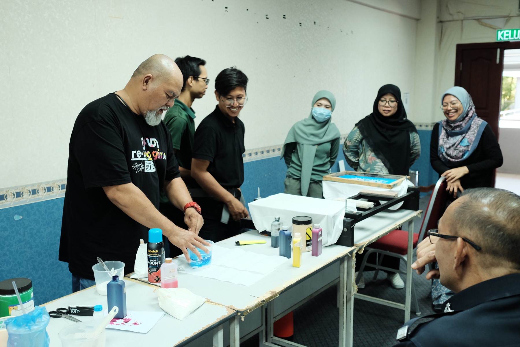 UiTM participants attending a hands-on T-shirt printing class conducted by Creativenest